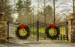 Christmas Wreaths on driveway steel gate with stone posts
