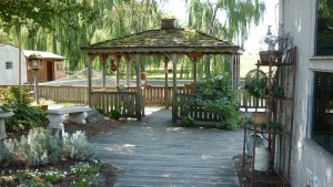 Gazebo on wood deck with wood fence