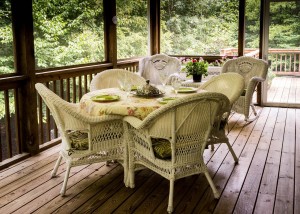 Patio Wicker Dining Table Set on Wood Deck in Screened in Patio
